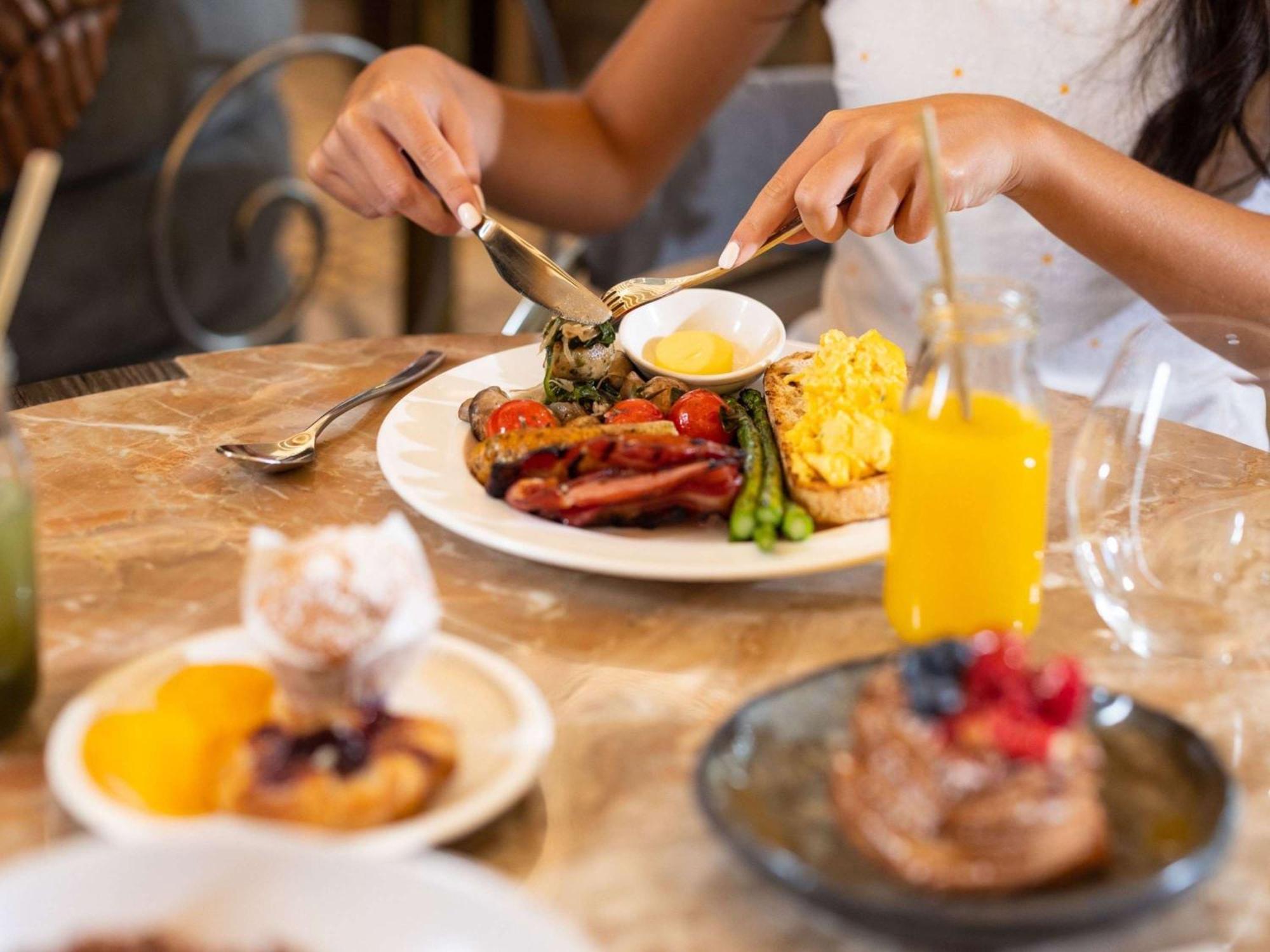 The Playford Adelaide - Mgallery Exteriör bild A woman eating breakfast